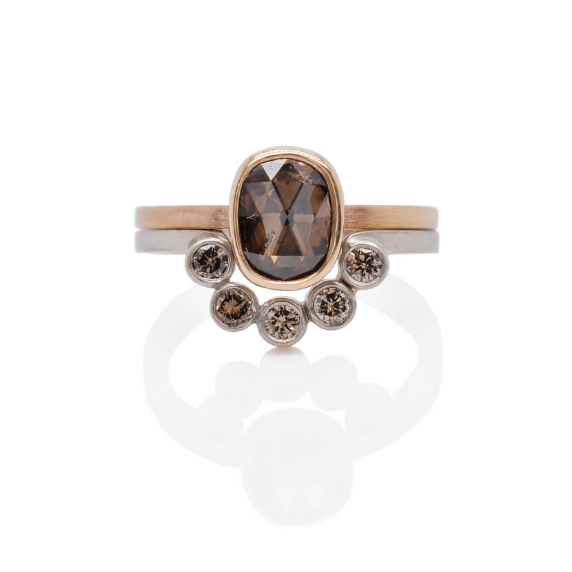  Pictured: Stacking ring set with a cognac colored rose cut diamond in a cushion cut shape, bezel set in 14k yellow gold on a delicate satin finish band.  Stacked with a half-halo band of sparkling champagne diamonds in 14k white gold bezels.