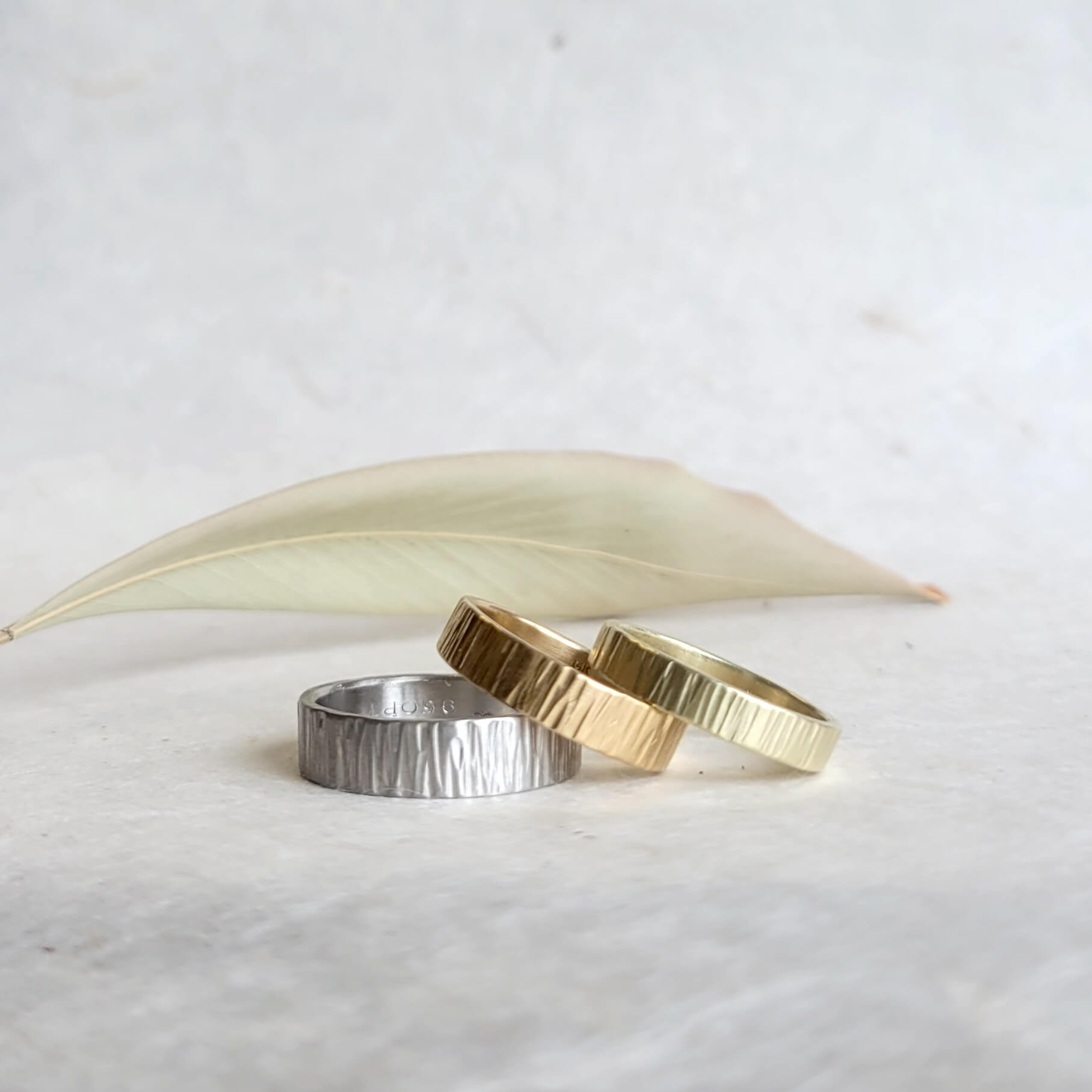 Linear hammered 14k yellow gold wedding band. Handmade by EC Design Jewelry in Minneapolis, MN using recycled metal.
