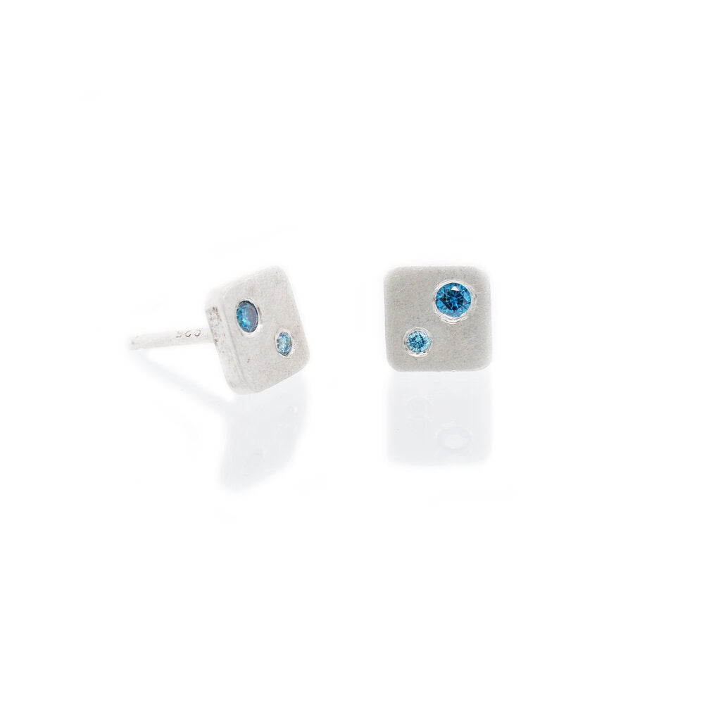 Sterling silver square studs with teal and aqua diamonds. Handmade by EC Design Studio in Minneapolis, MN using recycled metal and conflict-free stones.