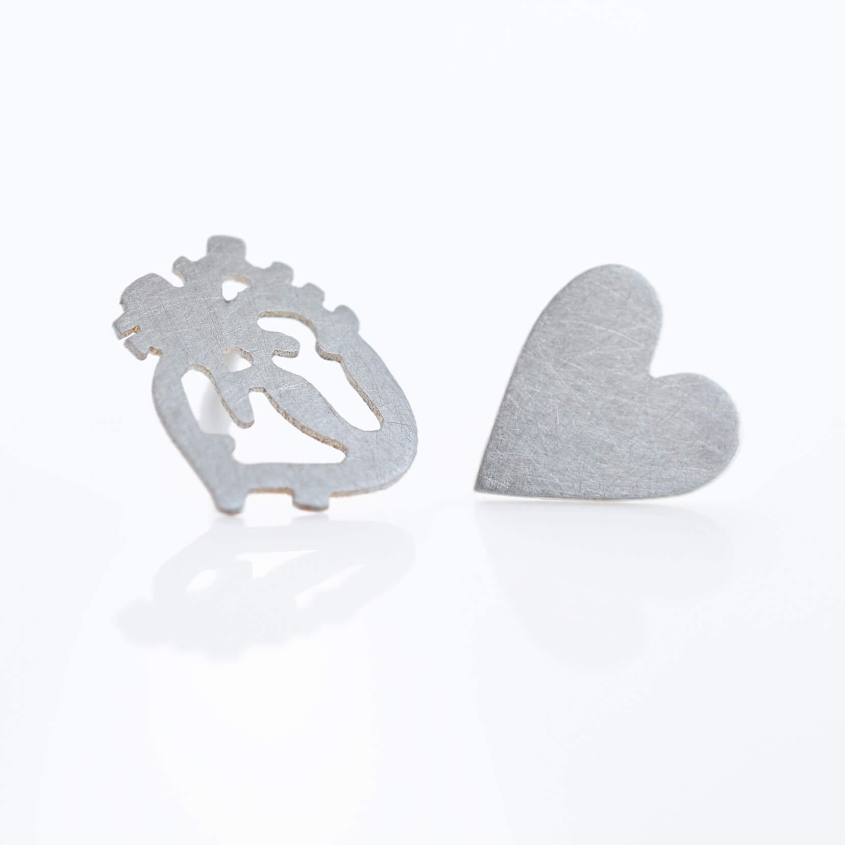 Sterling silver heart earrings. Handmade by EC Design in Minneapolis, MN with recycled metals.
