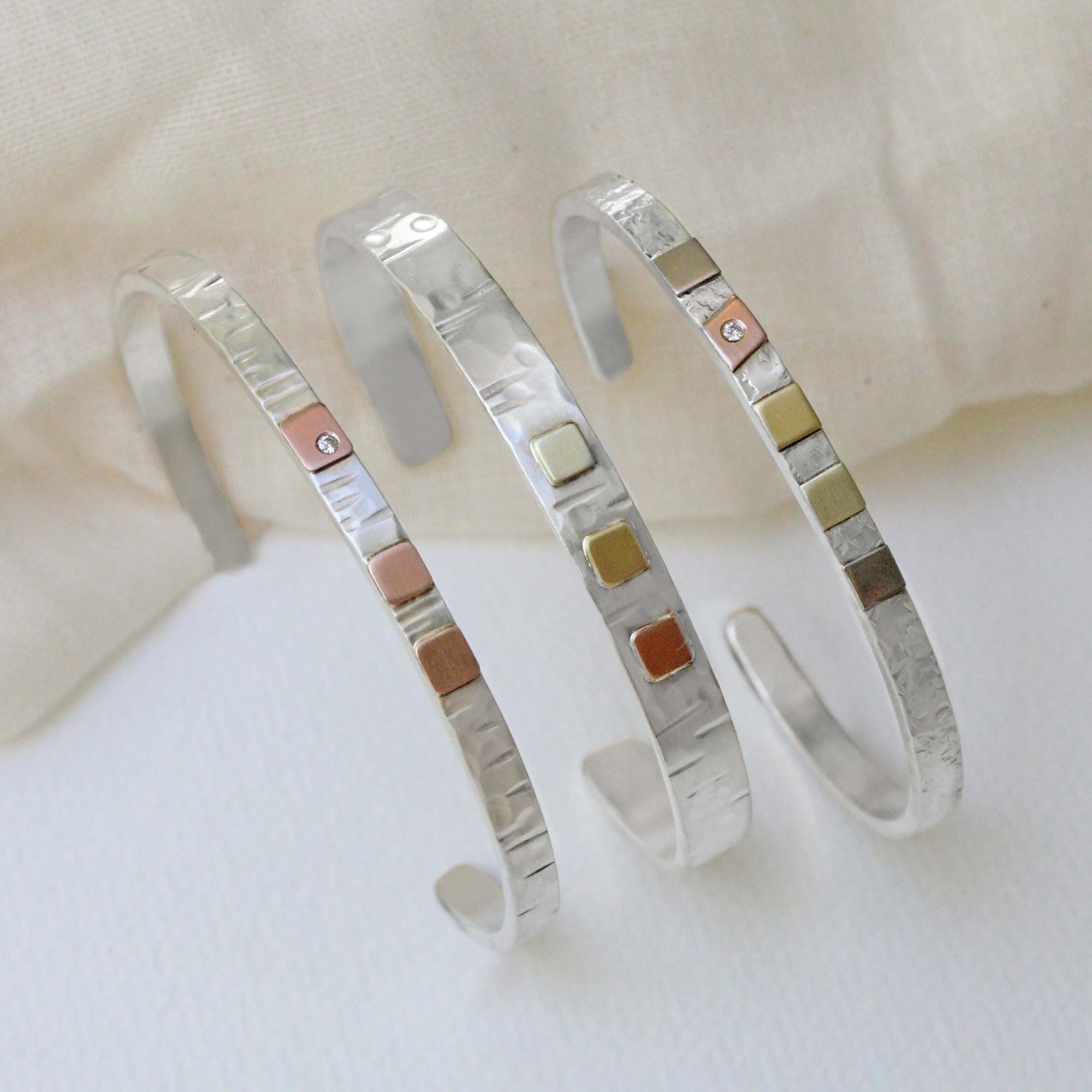 Sterling silver and mixed gold cuff bracelets from EC Design Jewelry in Minneapolis, MN. Handmade with recycled metal.