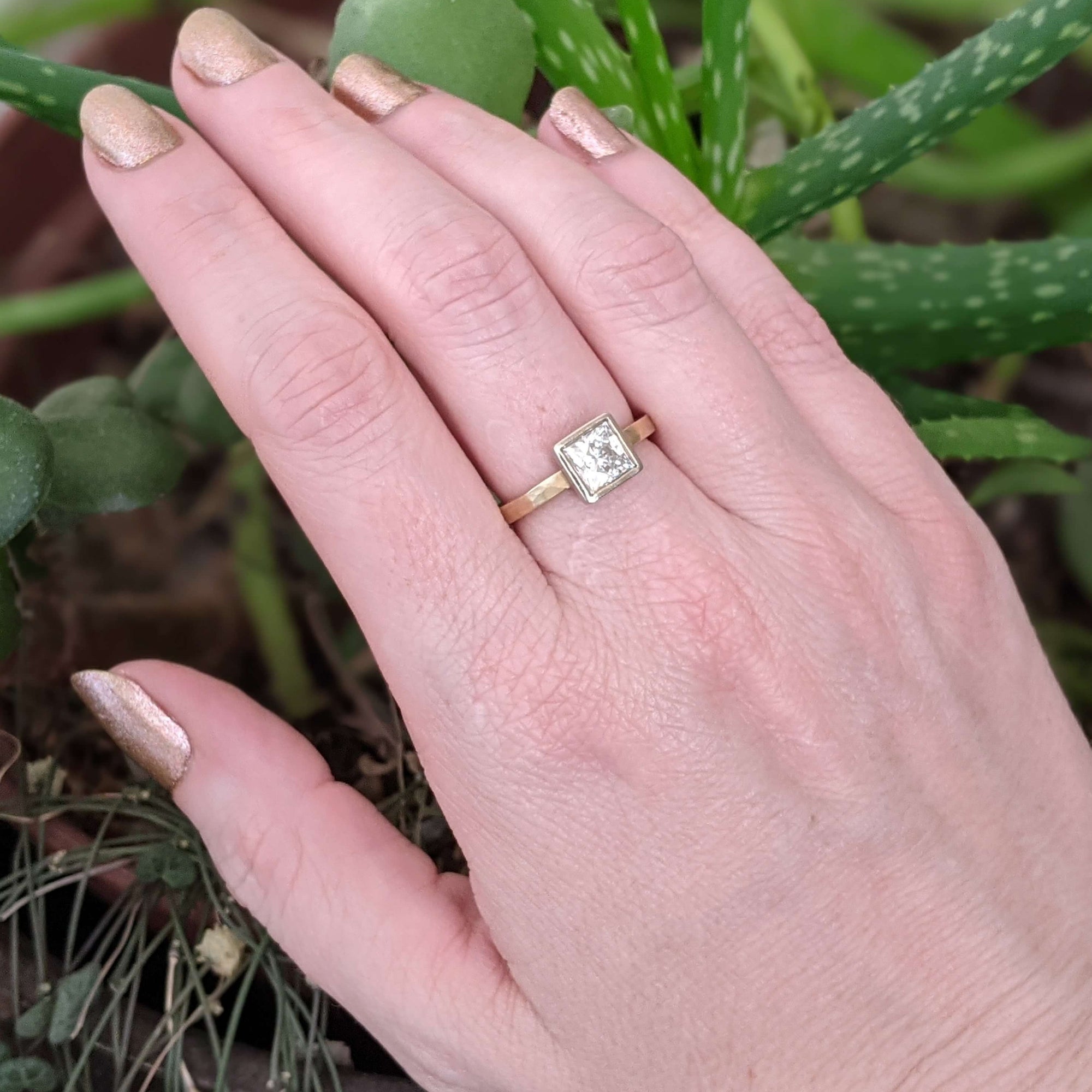 Alternative engagement ring with princess cut Moissanite in white and yellow gold. Handmade by EC Design Jewelry in Minneapolis, MN using recycled metal and conflict-free stone.