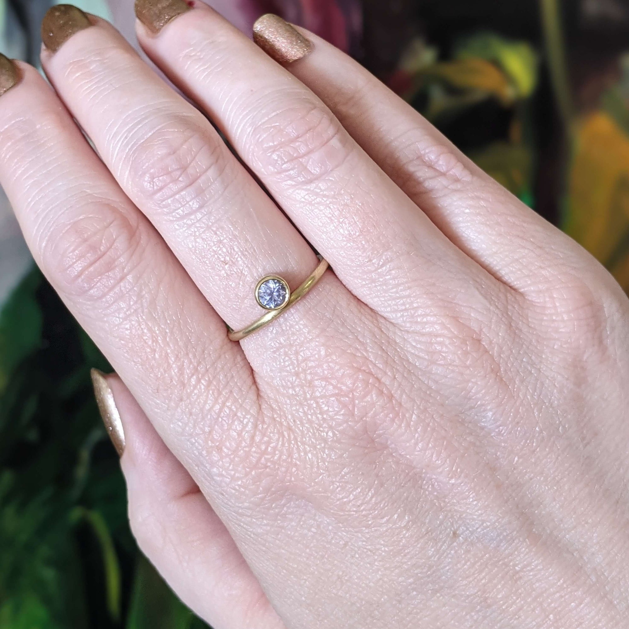 Light purple sapphire solitaire in yellow gold. Handmade with recycled metal and conflict-free stone by EC Design Jewelry in Minneapolis, MN.