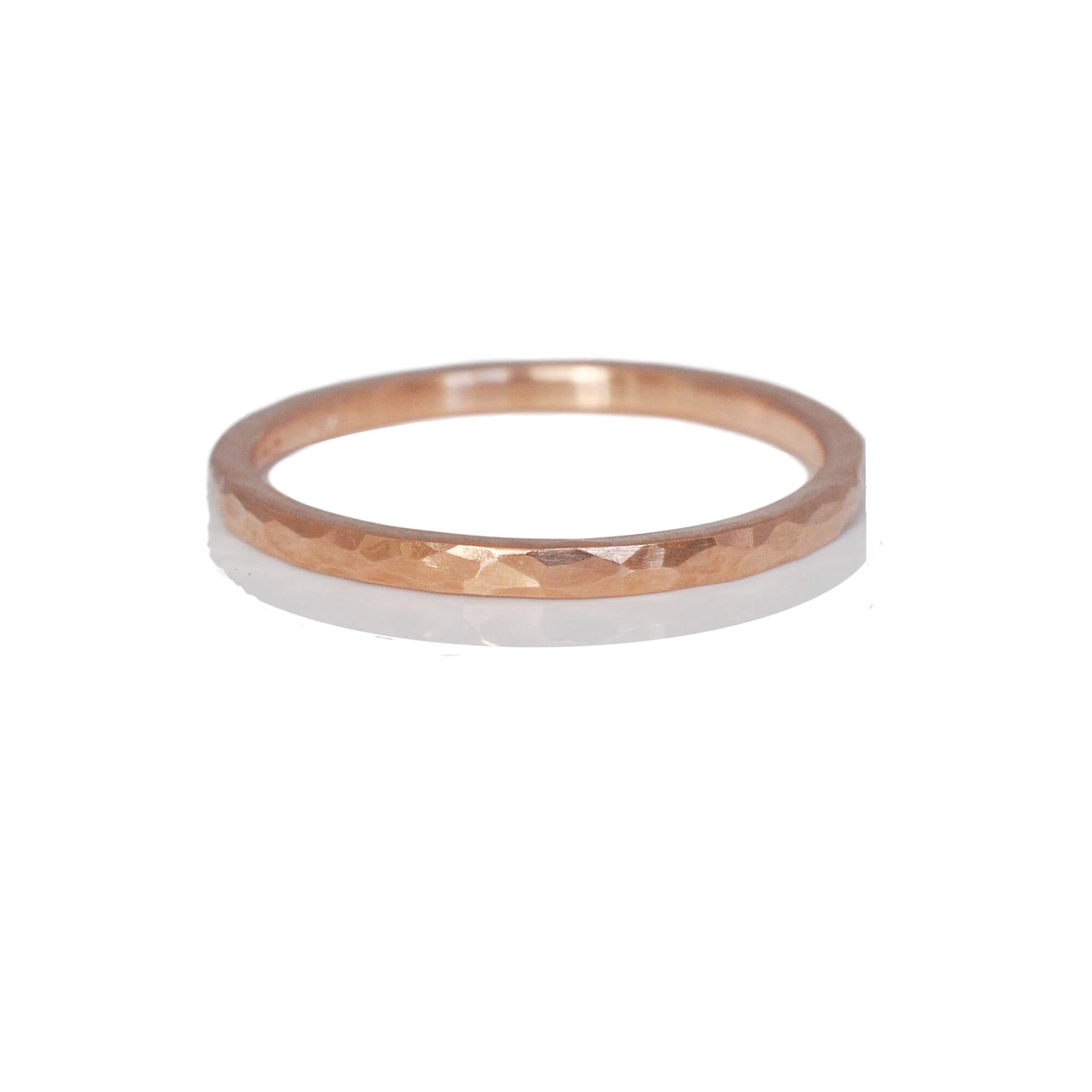 Hammered rose gold wedding band in a stackable 1.5mm size. Handmade by EC Design Jewelry in Minneapolis, MN.
