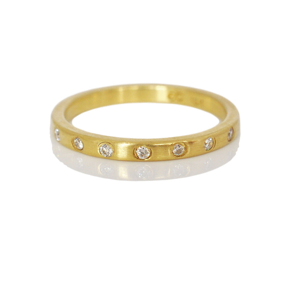 Satin 18k yellow gold half eternity band with Canadian mined white diamonds. Handmade with recycled metal and conflict-free stones by EC Design Studio in Minneapolis, MN.