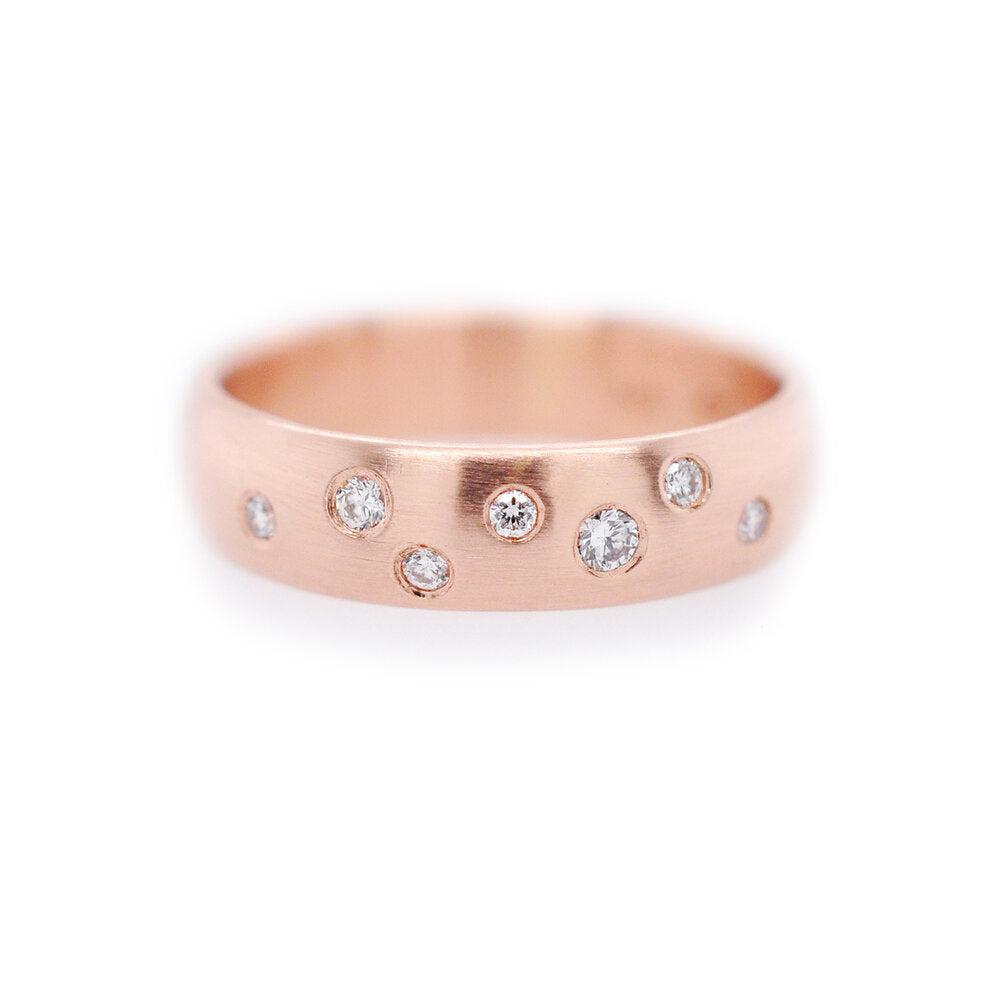 Red gold low dome band with scattered Canadian mined white diamonds. Handmade by EC Design Studio in Minneapolis, MN using recycled metal and conflict-free stones.