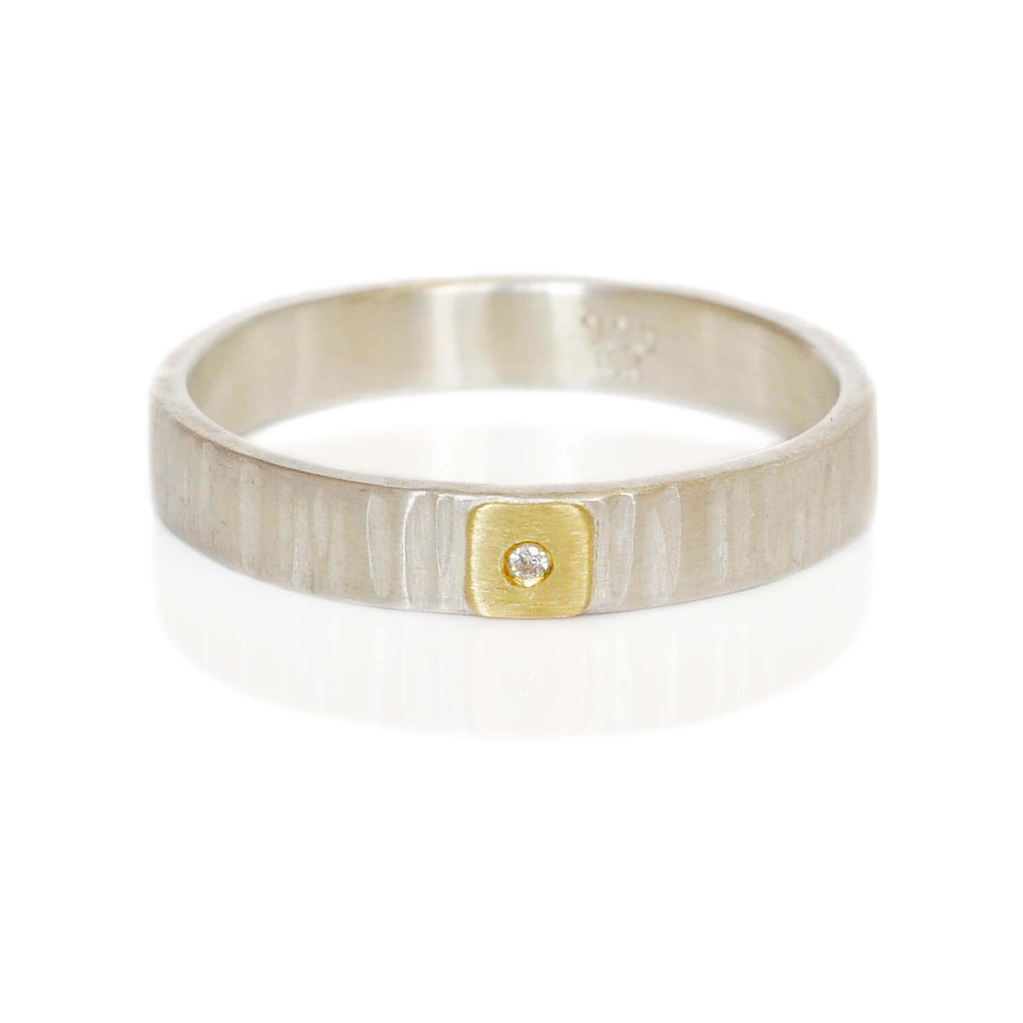 Diamond wedding band in linear hammered silver and yellow gold. Handmade by EC Design in Minneapolis, MN using recycled metal.