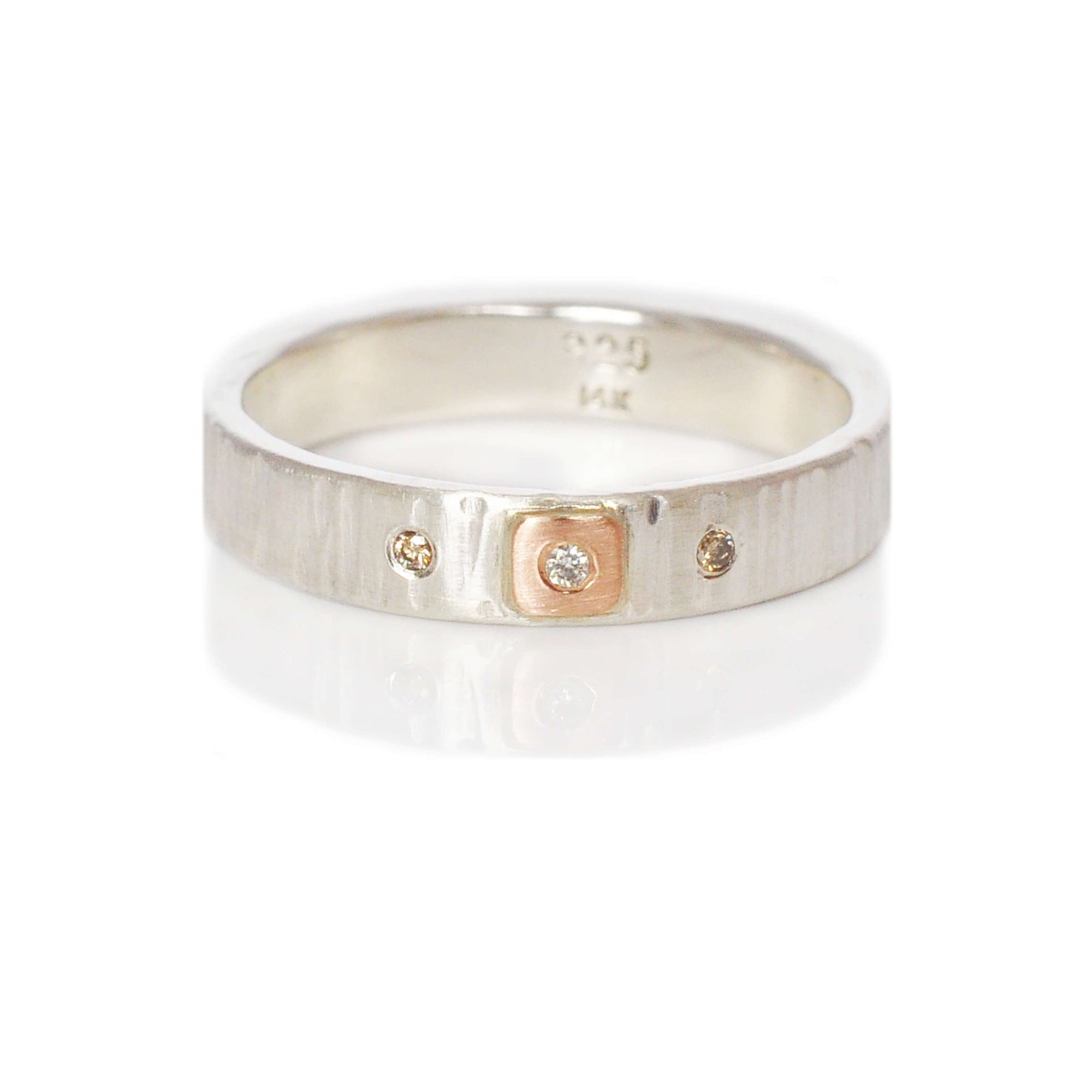 Linear hammered sterling silver band with rose gold and diamond accents. Handmade by EC Design Jewelry in Minneapolis, MN.