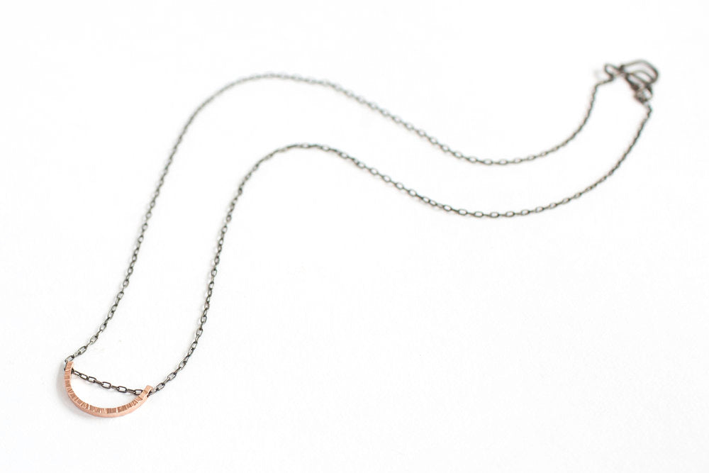Linear hammered red gold half moon necklace. Handmade by EC Design using recycled metal.
