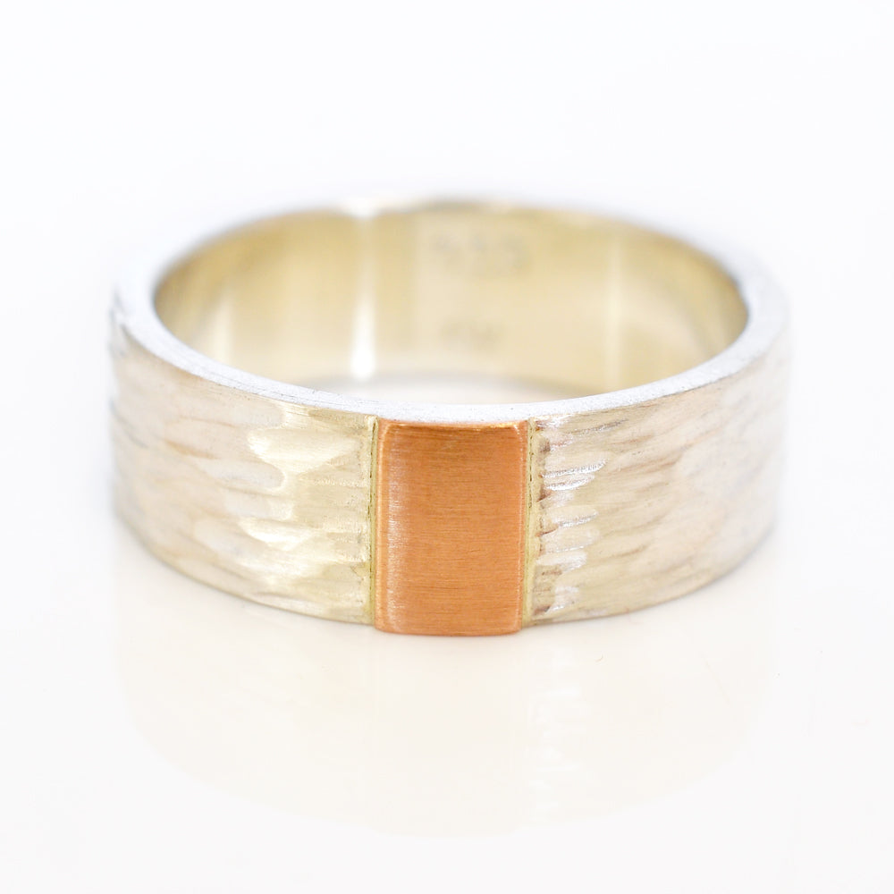 Hammered sterling silver band with red gold accent. Handmade by EC Design in Minneapolis, MN using recycled metal.