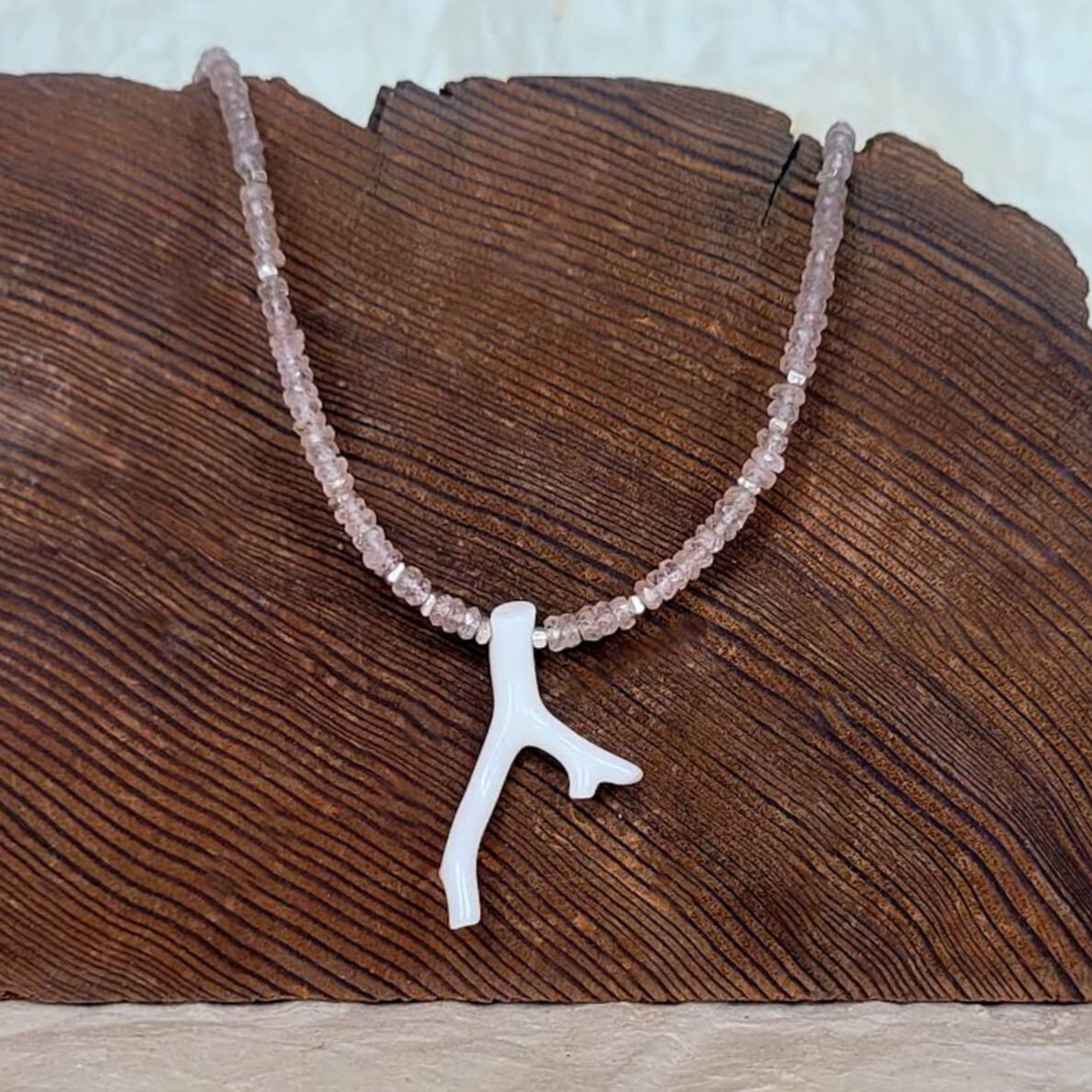 White Coral Branch on a Faceted Peach Sapphire Bead Strand
