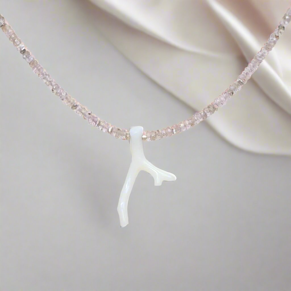 White Coral Branch on a Faceted Peach Sapphire Bead Strand