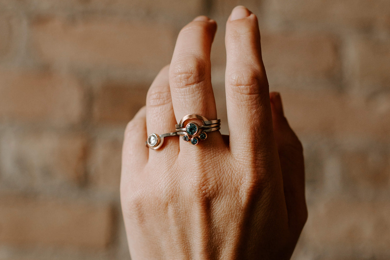 Mixed metal diamond and sapphire rings. Handmade by EC Design Jewelry in Minneapolis, MN using recycled metal and conflict-free stones.