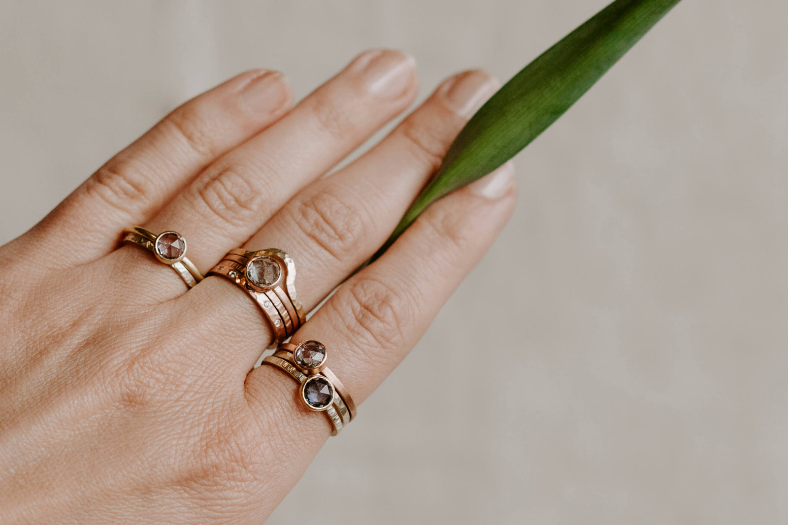 Mixed metal bands and solitaires from EC Design in Minneapolis, MN. Each ring is handmade with recycled metal and conflict-free stones.