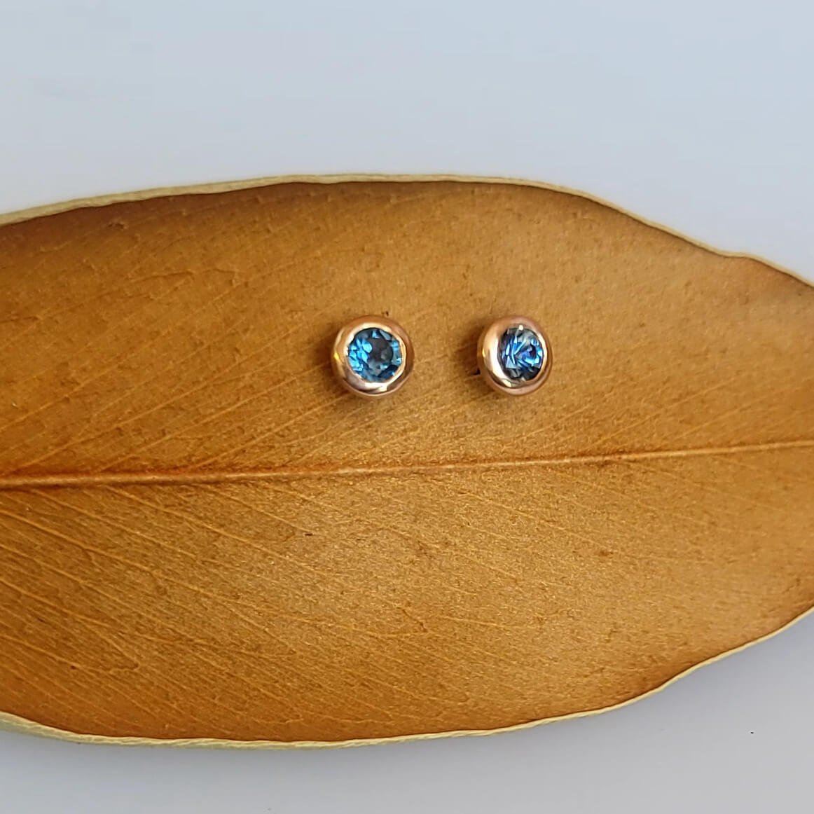 Montana sapphire stud earrings in recycled rose gold martini settings. Handmade by EC Design Jewelry in Minneapolis, MN.