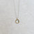 Handmade necklace with white rose cut sapphire bezel set in yellow gold. Made by EC Design Jewelry in Minneapolis, MN.