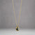 Diamond pendant in a solid gold setting on a gold chain.