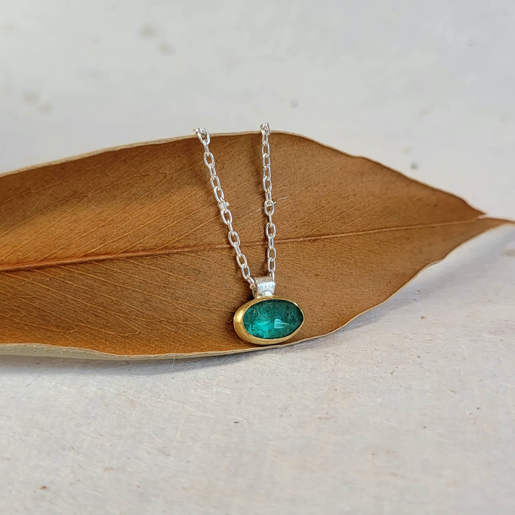 Emerald necklace with yellow gold bezel. Handmade by EC Design Jewelry in Minneapolis, MN.