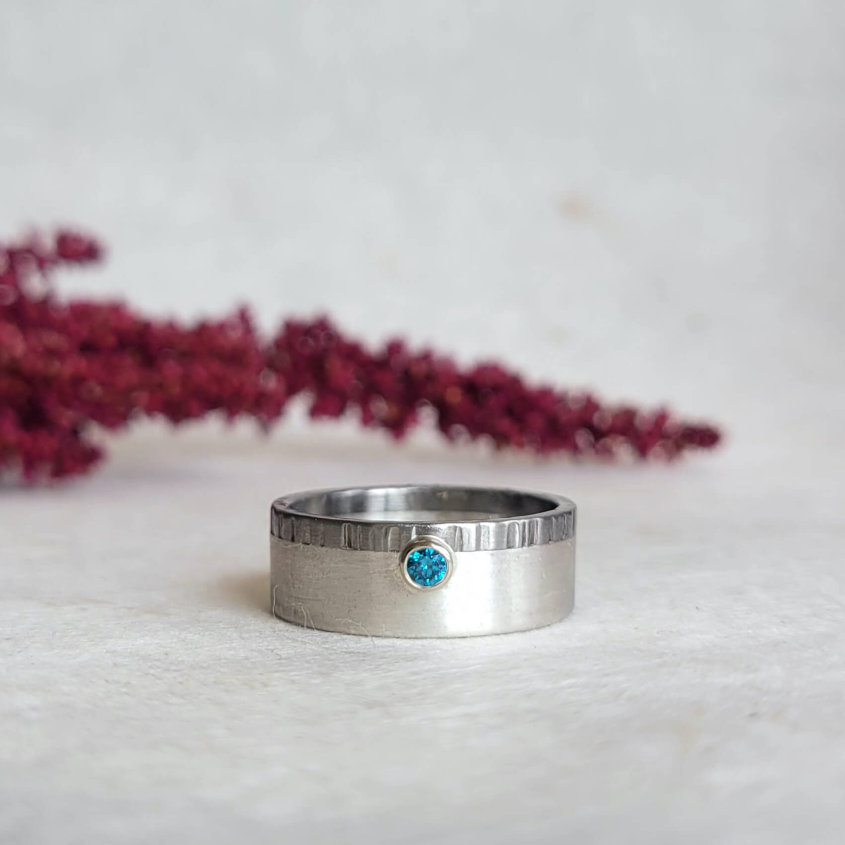 Mixed metal wedding band with blue diamond accent. Handmade by EC Design Jewelry in Minneapolis, MN.