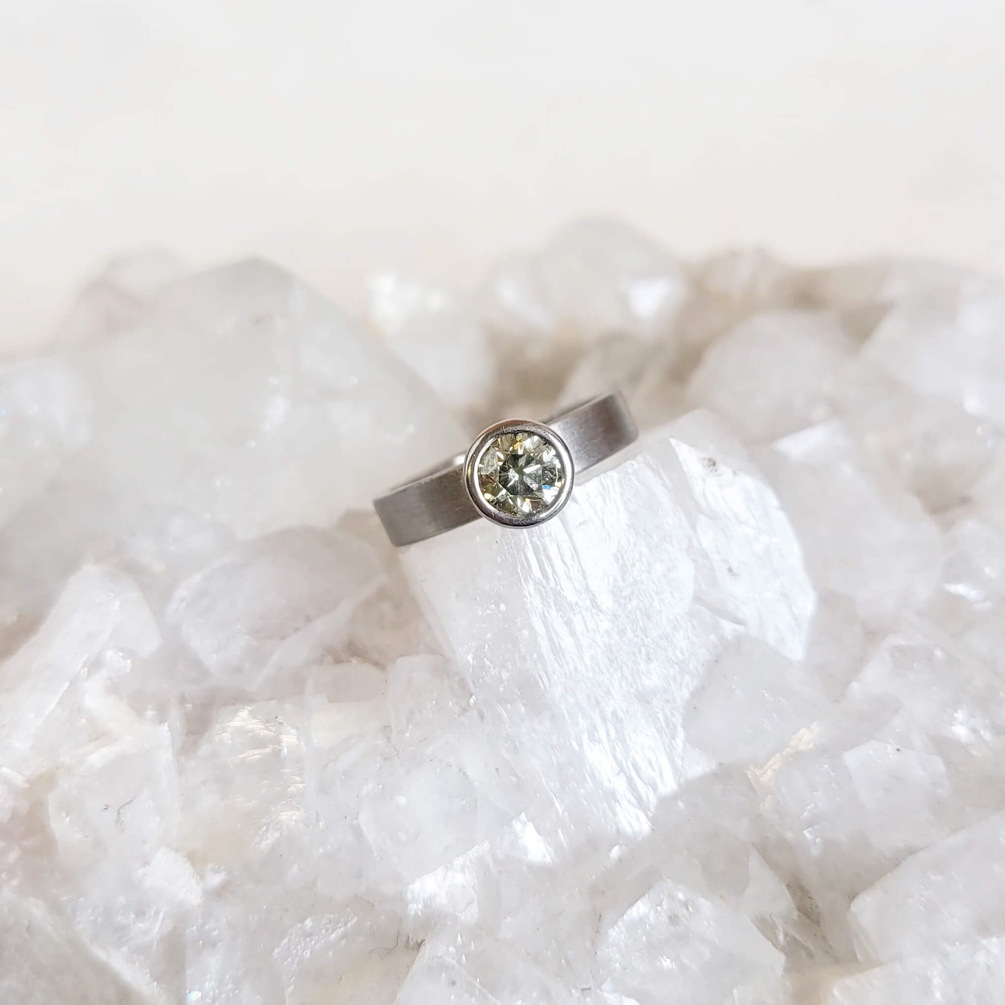 Modern engagement ring. Natural green brilliant cut diamond in palladium. Handmade by EC Design Studio in Minneapolis, MN using recycled metal and conflict-free stone.