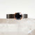 Round Brilliant Black Moissanite Ring in a Half Bezel