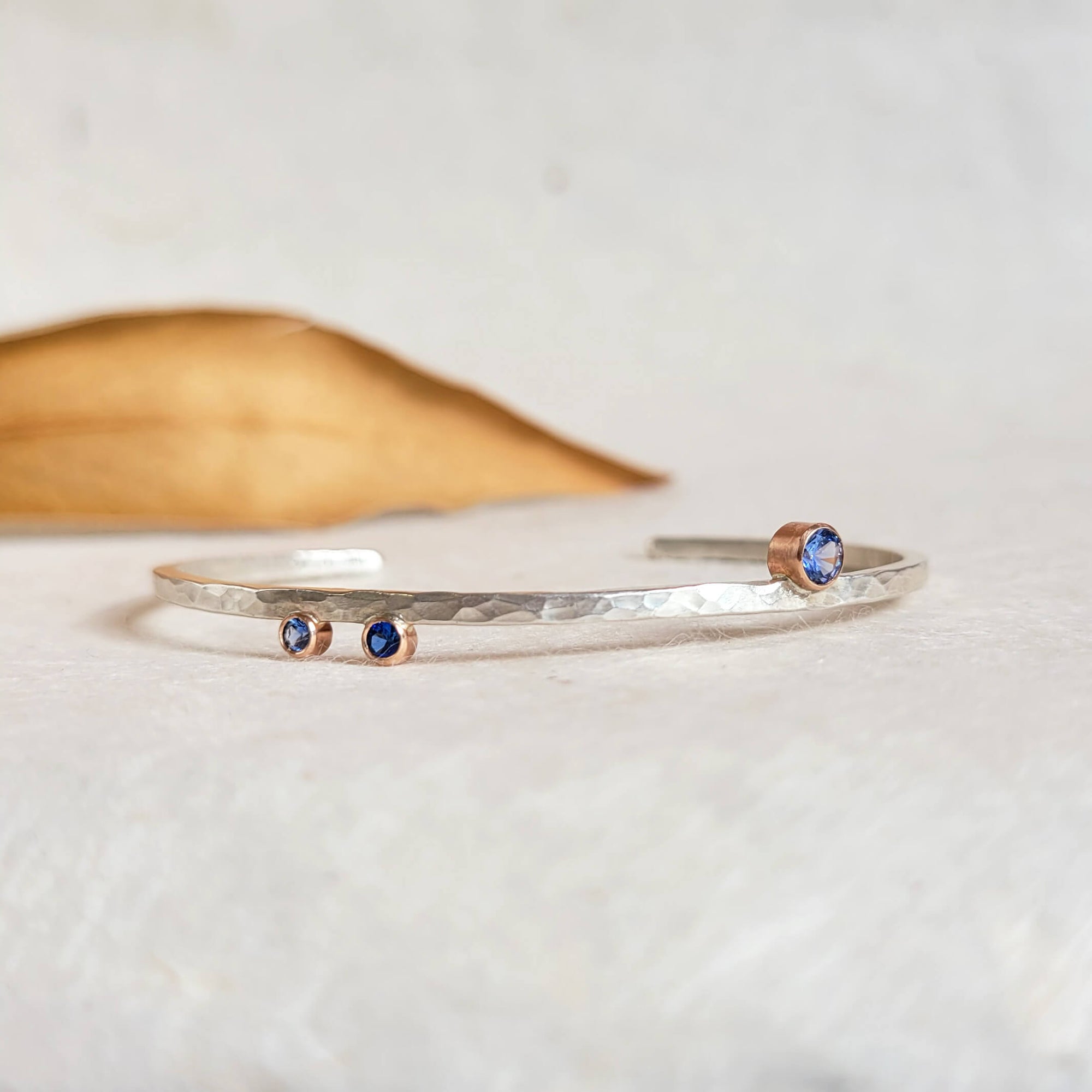 Brilliant Blue Sapphire Cuff Bracelet in Hammered Sterling Silver and Rose Gold