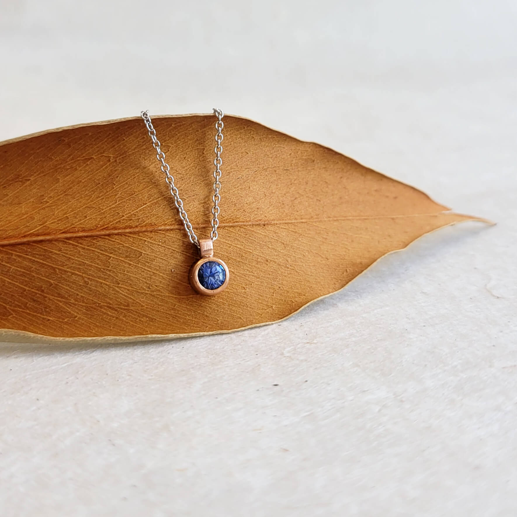 Blue Sapphire and Rose Gold Bezel Set Necklace