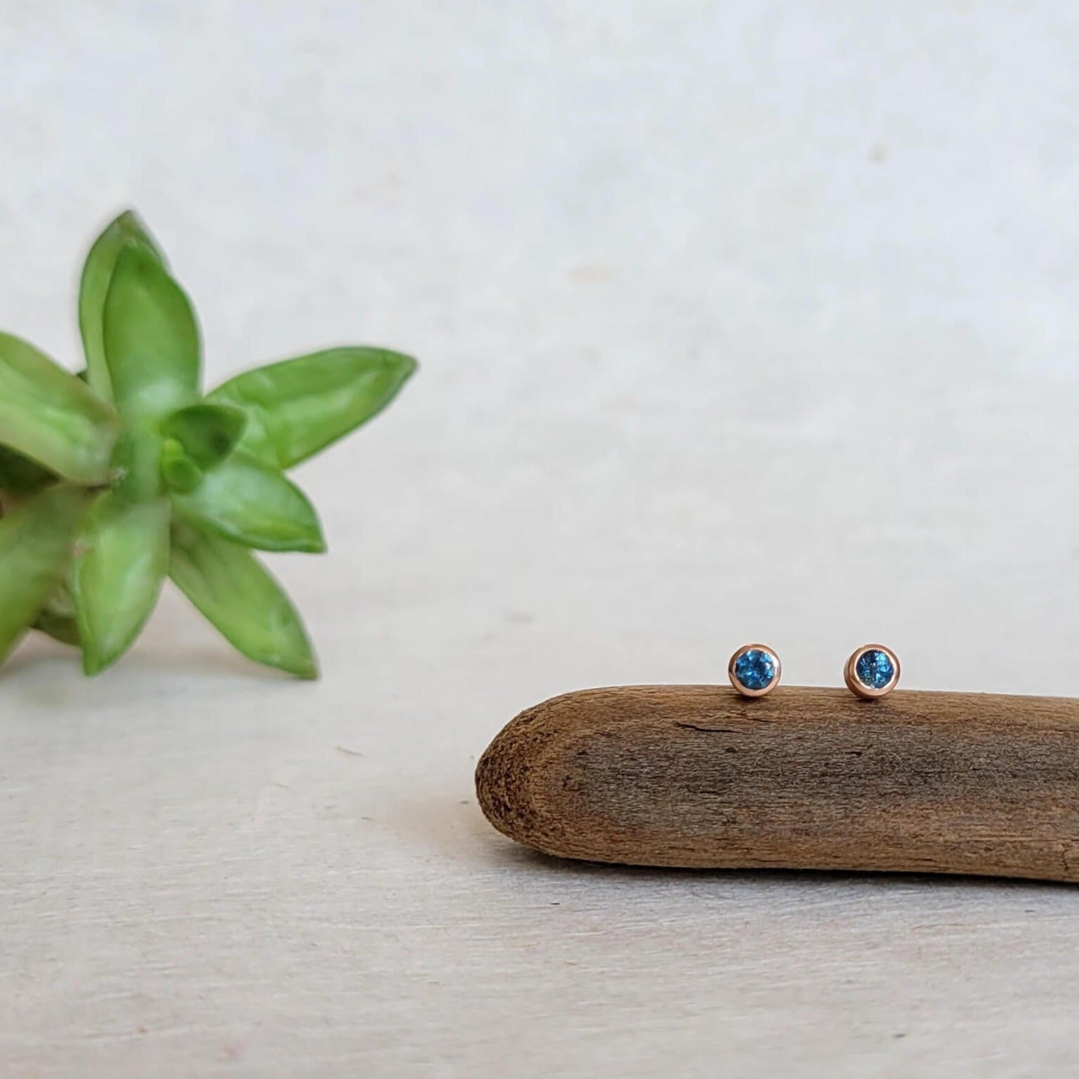 Blue sapphire stud earrings bezel set in rose gold. Handmade with recycled metal and conflict-free stones.