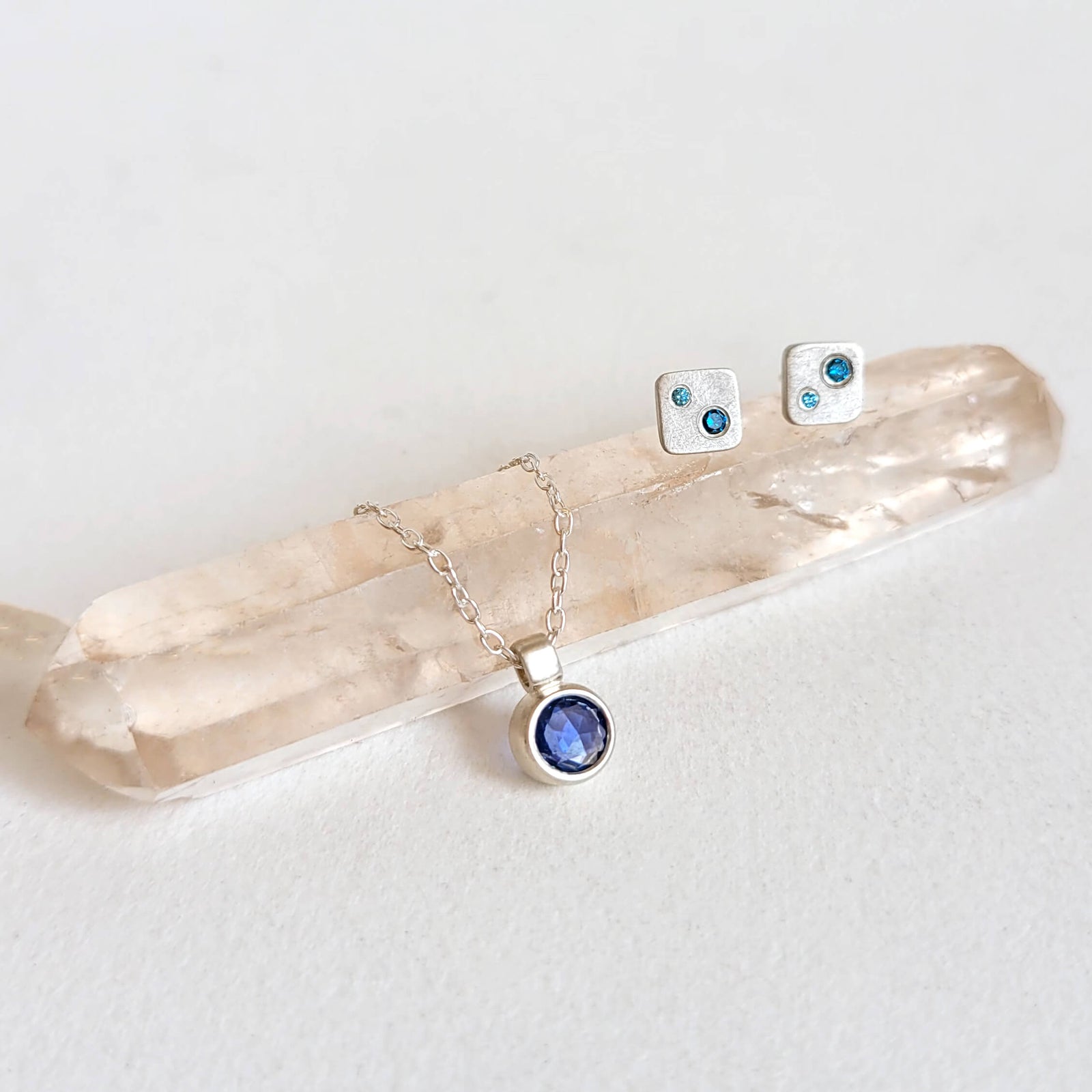 Sterling silver square studs with teal and aqua diamonds. Handmade by EC Design Studio in Minneapolis, MN using recycled metal and conflict-free stones.