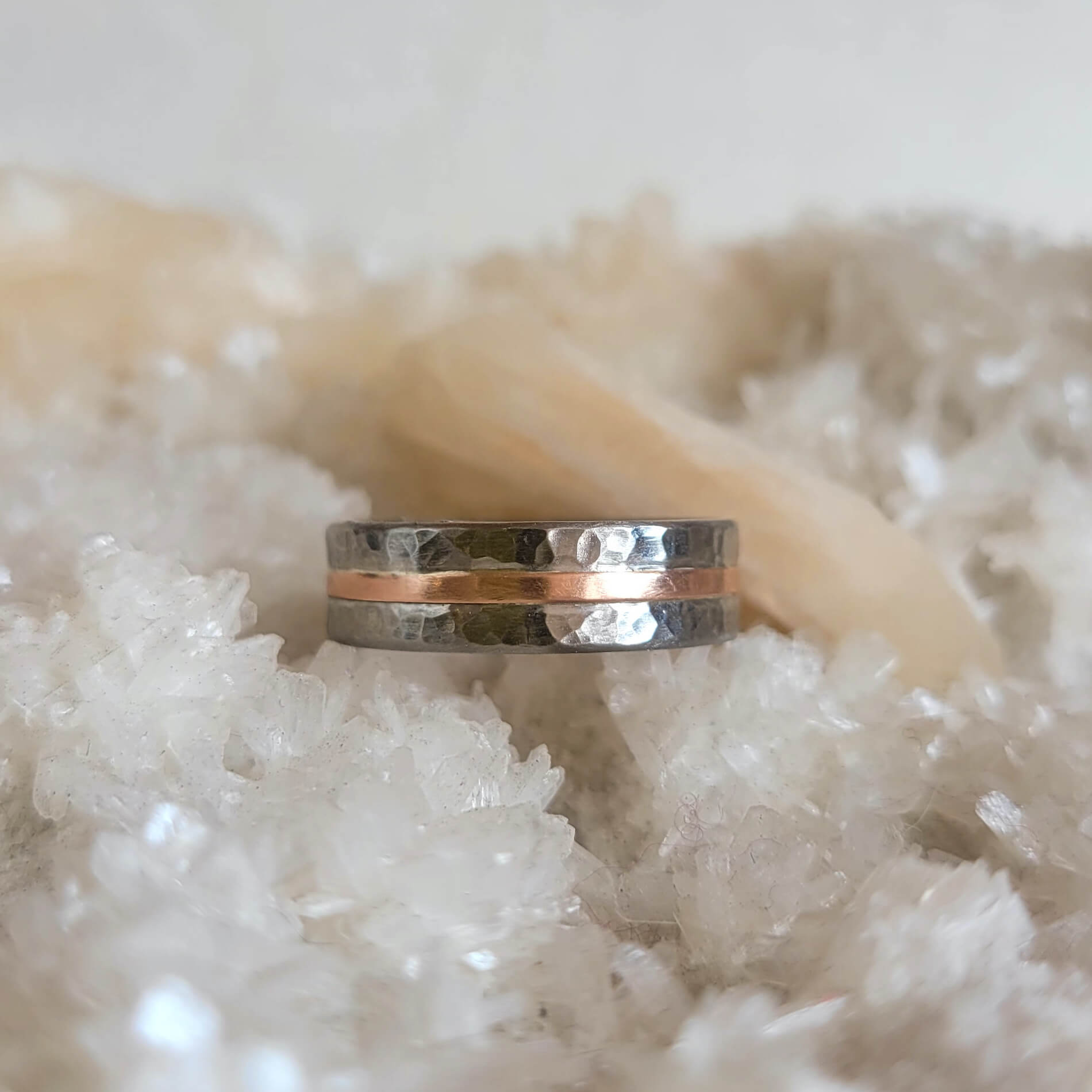 Hand hammered palladium and rose gold wedding band made by EC Design Jewelry in Minneapolis, MN.