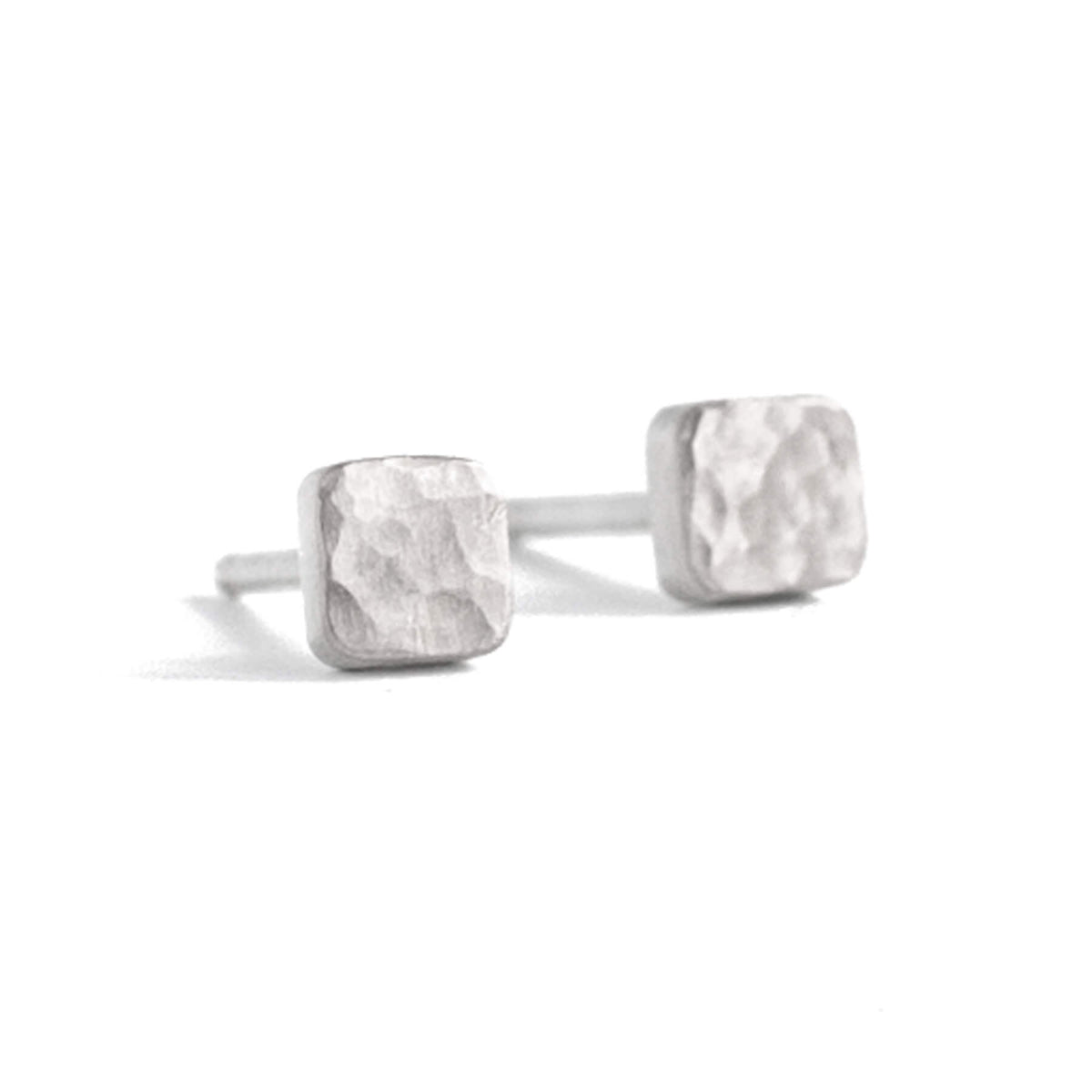 Sterling silver square studs in round hammered finish. Handmade by EC Design Studio in Minneapolis, MN using recycled metal.