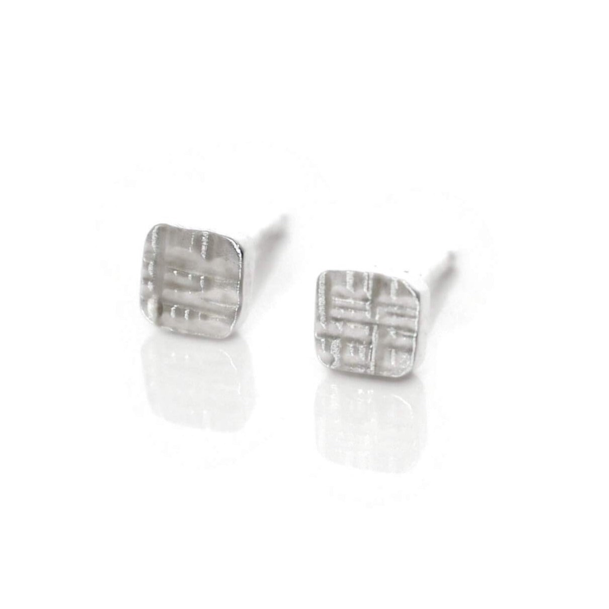 Sterling silver square studs in round hammered finish. Handmade by EC Design Studio in Minneapolis, MN using recycled metal.