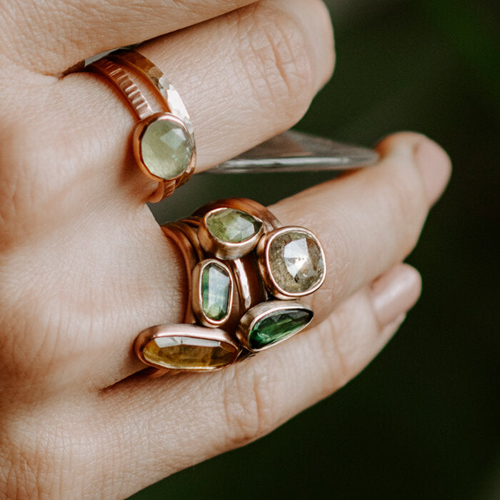 Collection of green sapphire rings, handmade by EC Design in Minneapolis, MN.