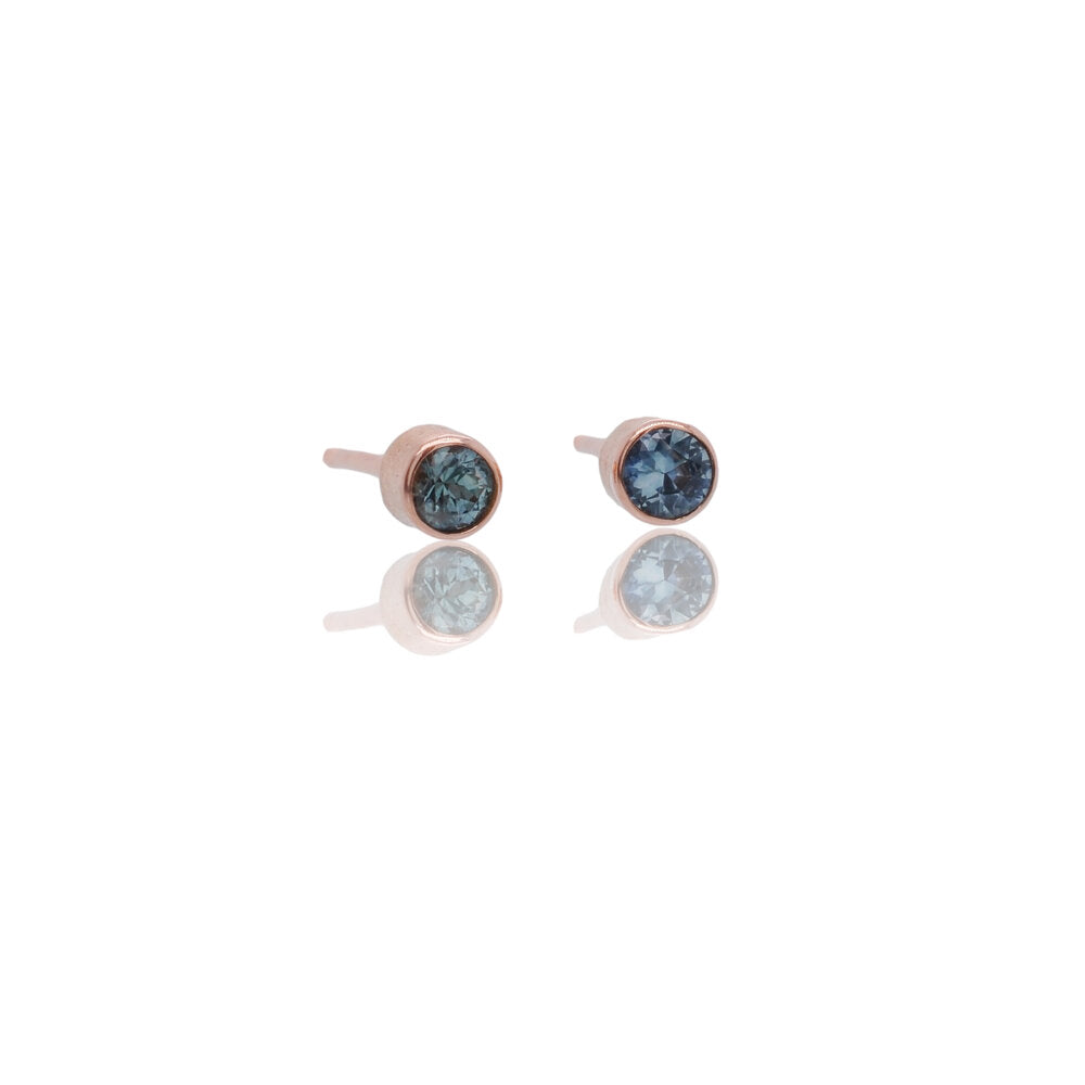 Blue Montana sapphire stud earrings in rose gold settings. Made with recycled metal and conflict-free stones.