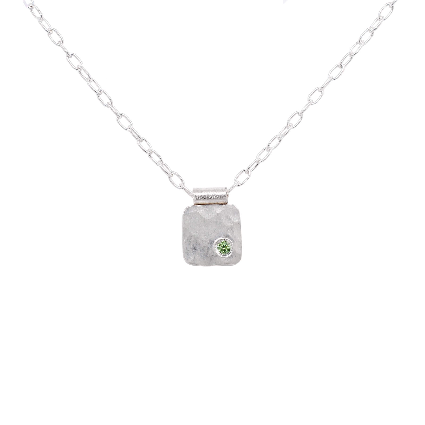 Hammered silver cell necklace with lime green diamond accent. Handmade by EC Design Jewelry in Minneapolis, MN.