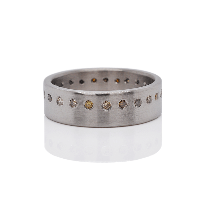 Satin finished palladium wedding band with flush set autumn diamonds. Handmade by EC Design Jewelry in Minneapolis, MN.