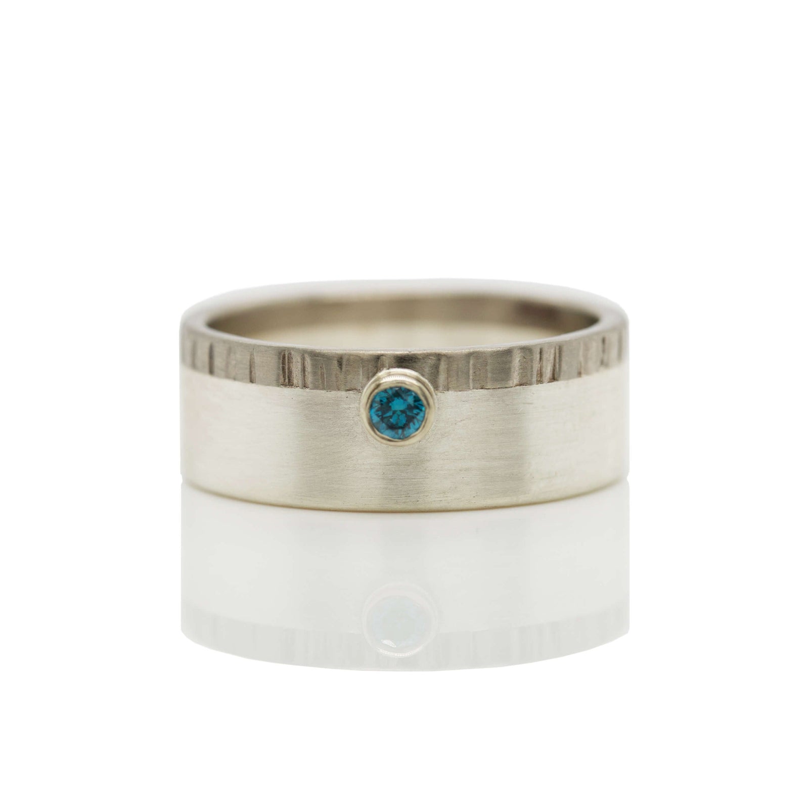 Mixed metal wedding band with blue diamond accent. Handmade by EC Design Jewelry in Minneapolis, MN.