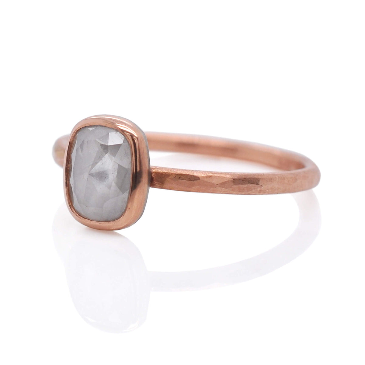 Rectangle diamond bezel set in rose gold on a matching rose gold band with a facet hammered finish.