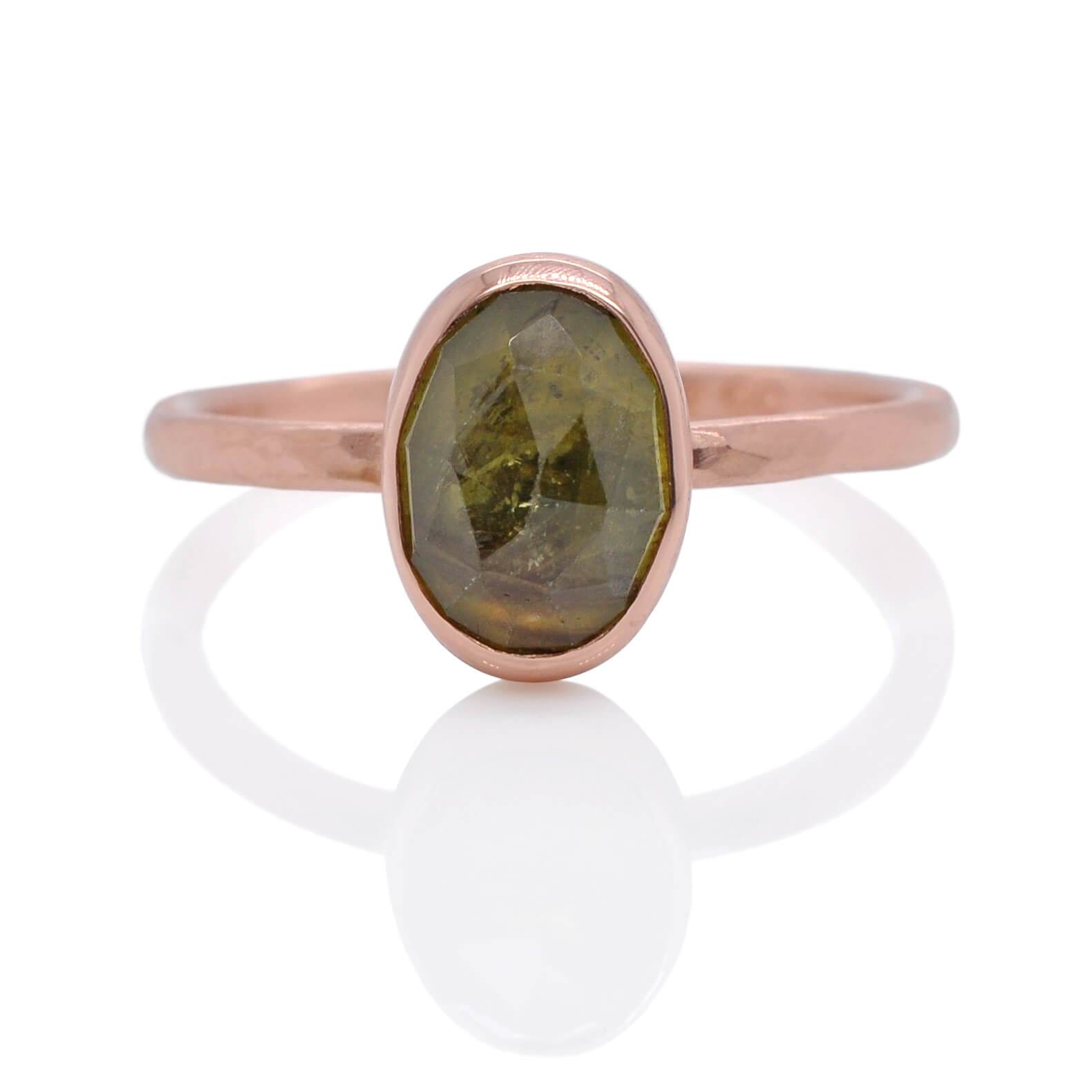 Green rose cut sapphire set in recycled rose gold.