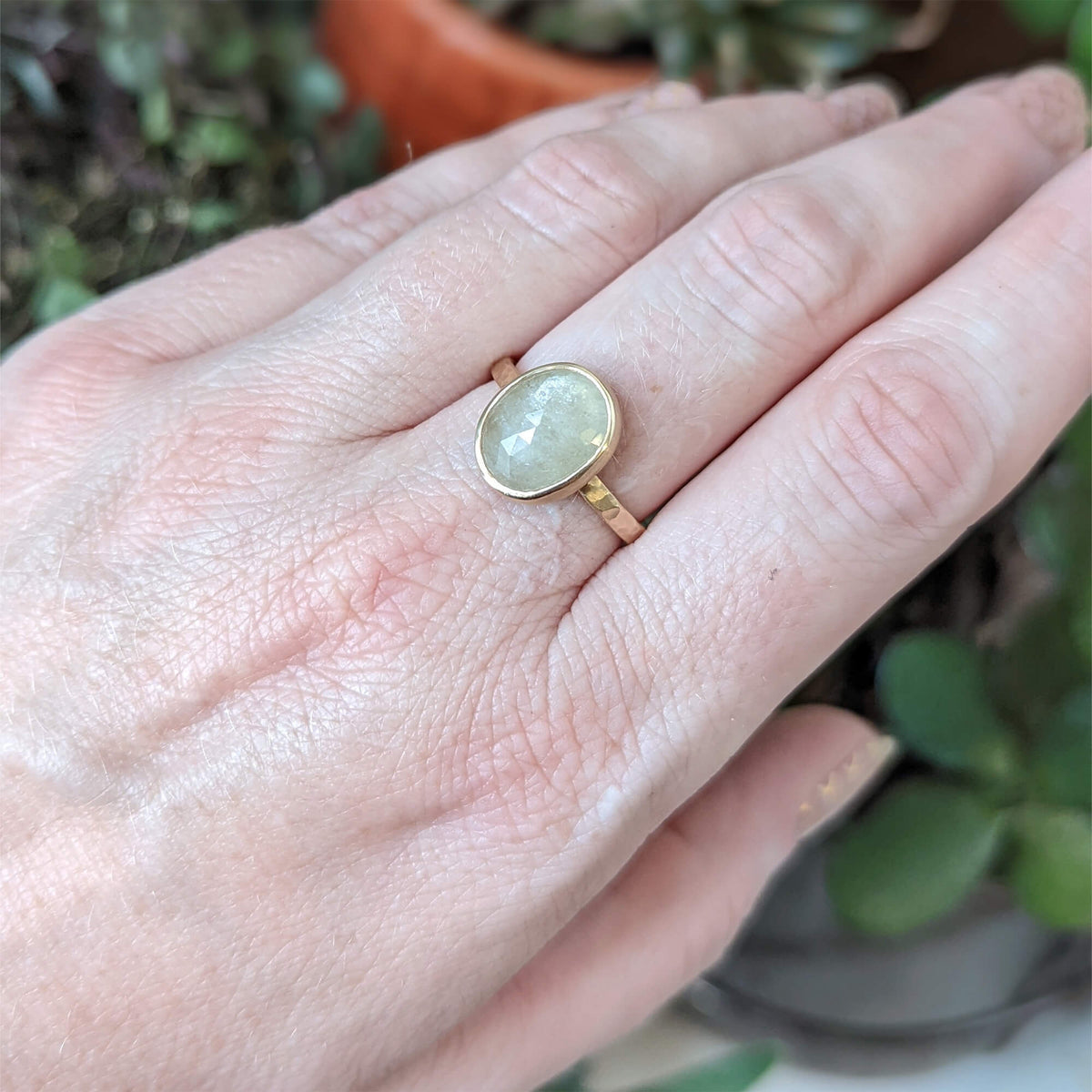 Creamy white rose cut sapphire in hand hammered yellow gold. Handmade by EC Design Jewelry in Minneapolis, MN.