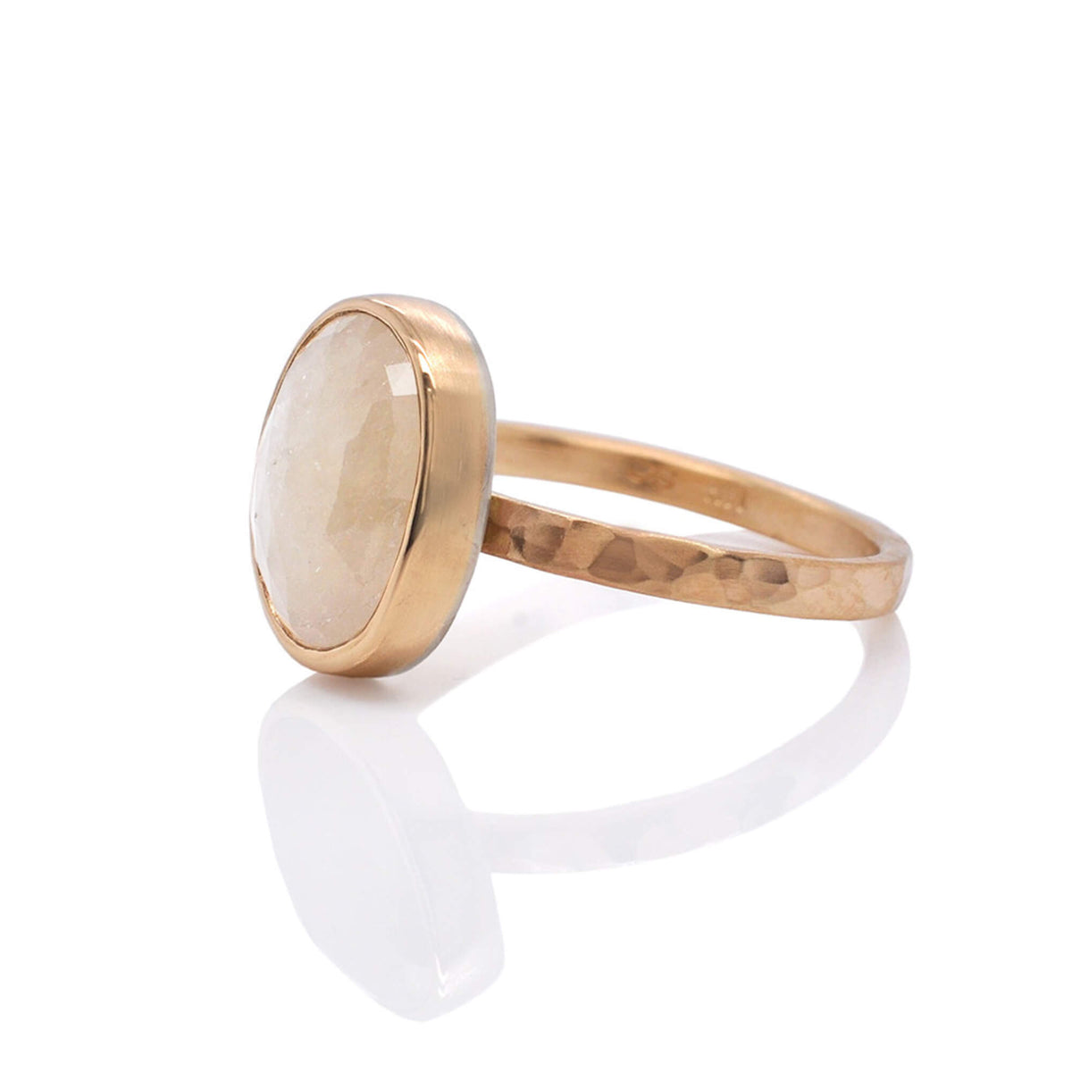 Side view of cream colored sapphire in yellow gold. Handmade by EC Design Jewelry in Minneapolis, MN.