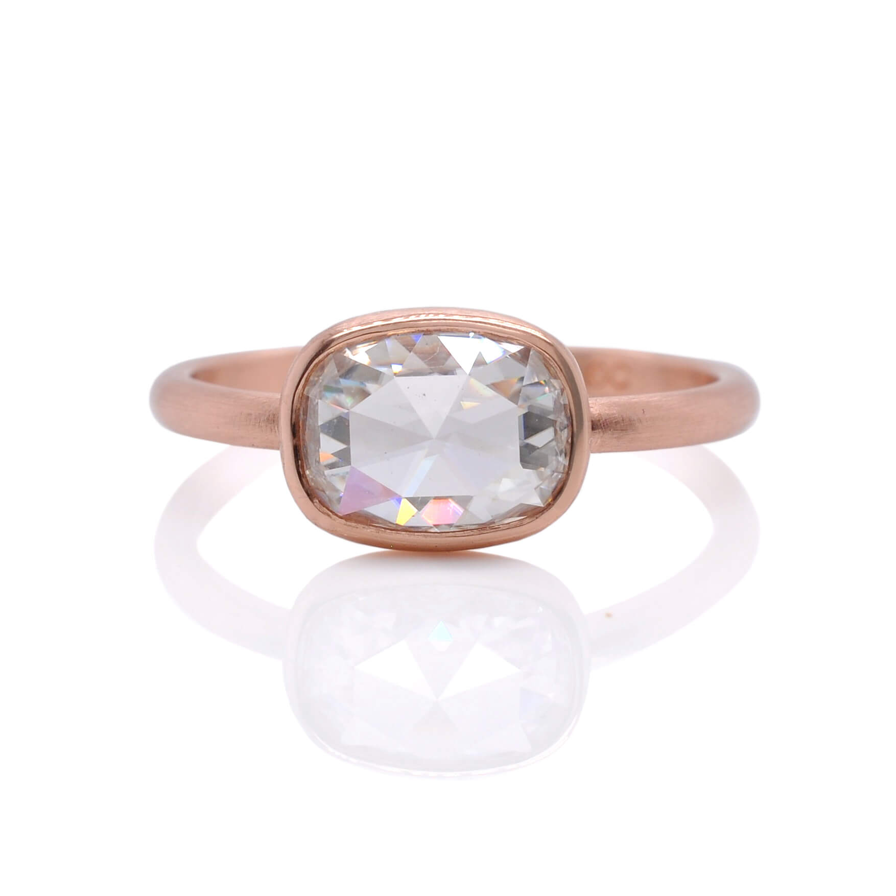 Cushion cut Moissanite engagement ring in satin finished rose gold.