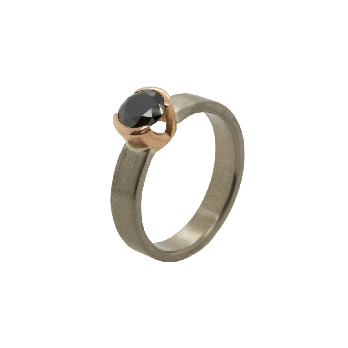 Round brilliant black Moissanite engagement ring in palladium with an open &#39;V&#39; bezel made of rose gold. Handmade by EC Design Jewelry in Minneapolis, MN.