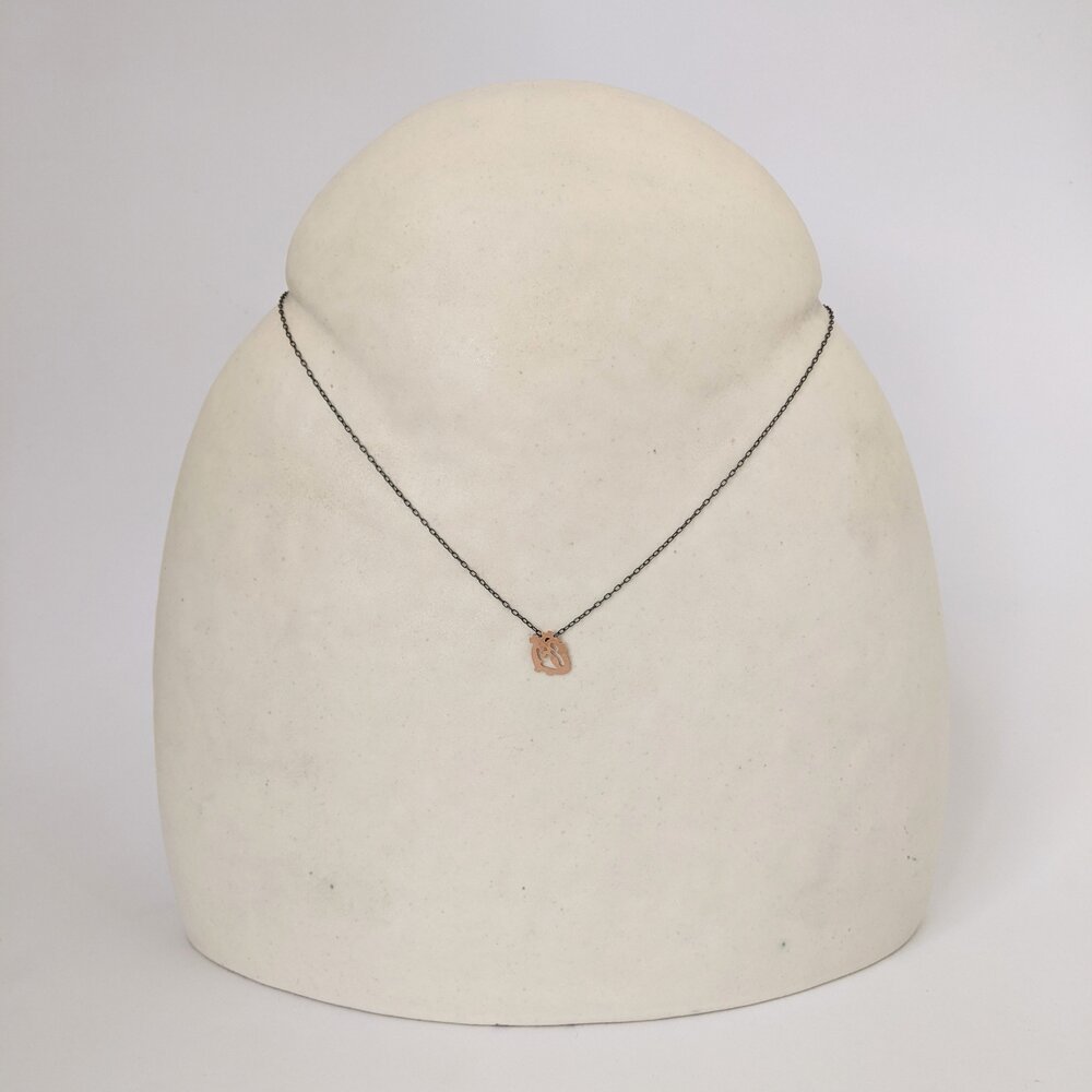 Rose gold anatomical heart on an oxidized silver chain. Handmade by EC Design Studio in Minneapolis, MN using recycled metal.