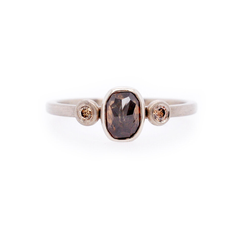 Palladium ring with a cognac diamond between champagne diamonds. Handmade by EC Design Studio in Minneapolis, MN using recycled metal and conflict-free stones. Perfect for a modern bride.