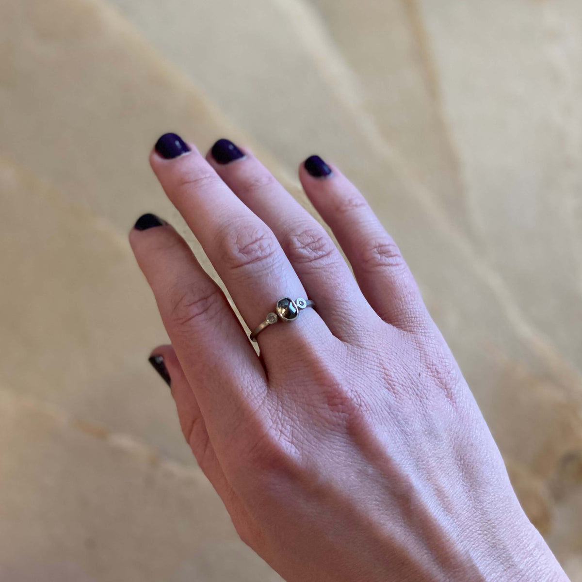 Palladium ring with a center rose cut cognac diamond and two brilliant cut champagne diamonds. Handmade by EC Design Studio in Minneapolis, MN using recycled metal and conflict-free stones.