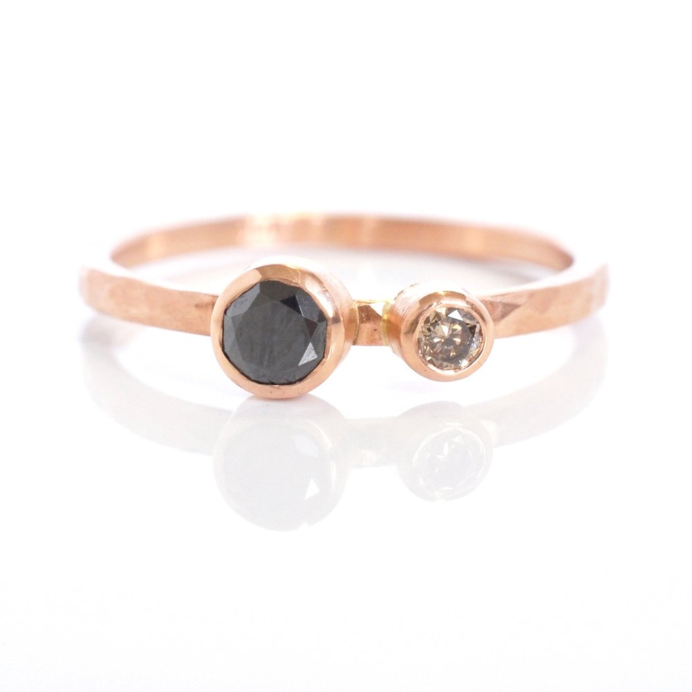 Hammered red gold ring with a rose cut black diamond along side a brilliant cut champagne diamond buddy. Handmade by EC Design Jewelry in Minneapolis, MN using recycled metal and conflict-free stones.
