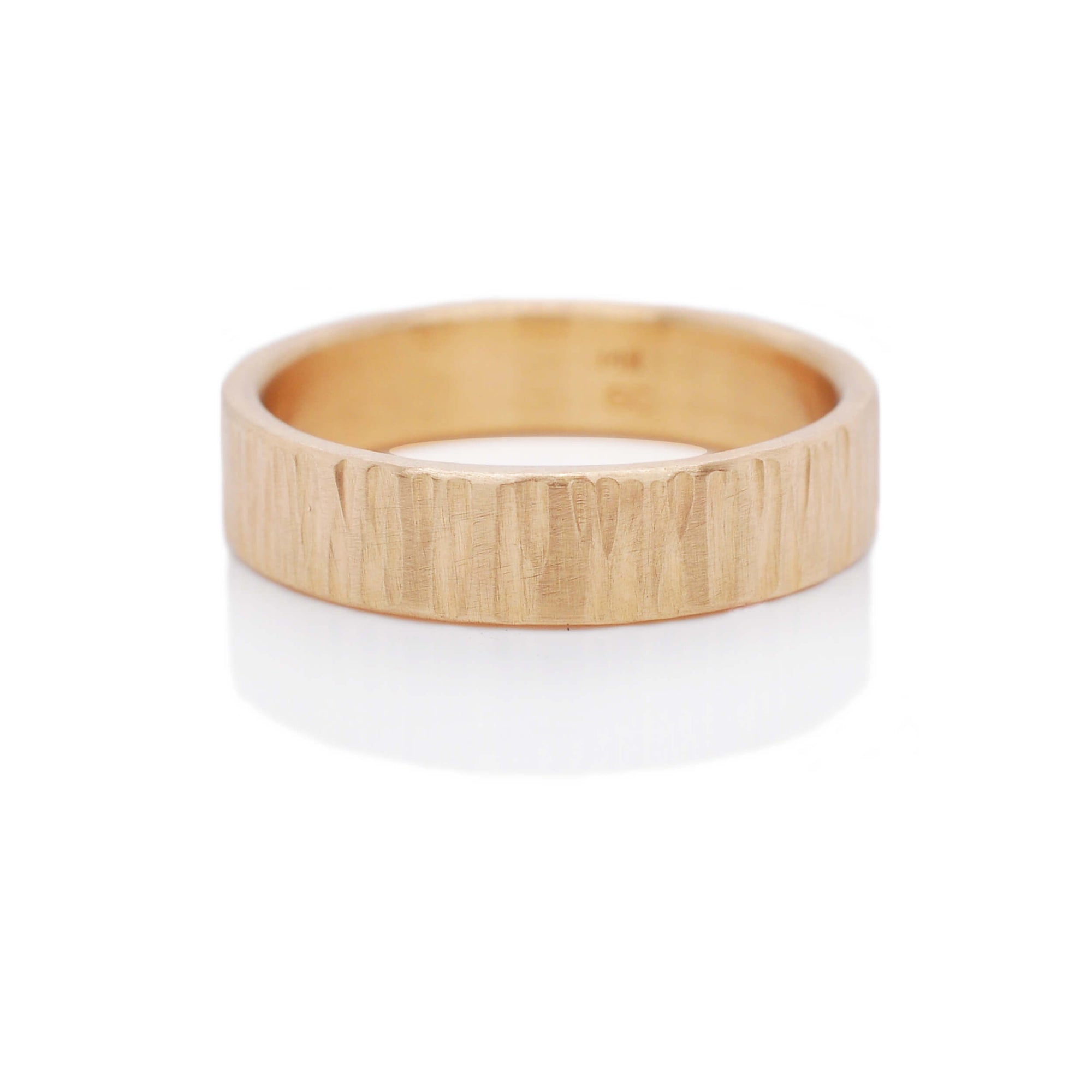 Linear hammered 14k yellow gold wedding band. Handmade by EC Design Jewelry in Minneapolis, MN using recycled metal.