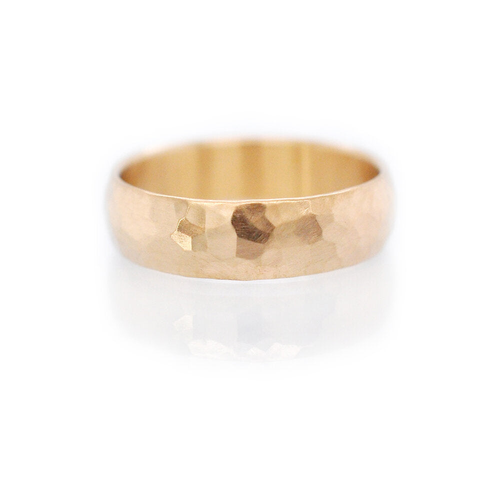 14k yellow gold facet hammered wide wedding band. Handmade by EC Design Jewelry in Minneapolis, MN using recycled metal.