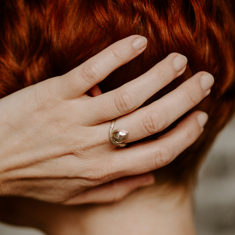 Pear shape diamond ring in yellow gold with flush set diamond band. Handmade by EC Design in Minneapolis, MN using recycled metal and conflict-free stones.